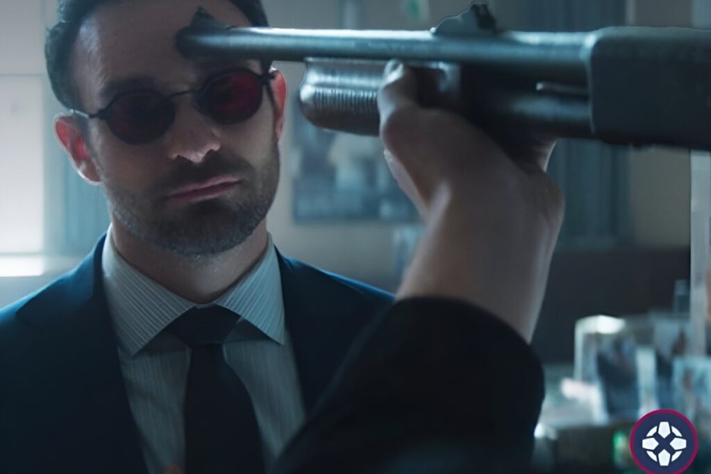 Matt Murdock, as Daredevil, is confronted with a gun pointed at his head in a tense scene.
