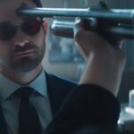 Matt Murdock, as Daredevil, is confronted with a gun pointed at his head in a tense scene.