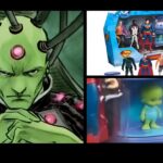 Close-up of green baby figure inside Superman toy set, possibly referencing Brainiac or alien.
